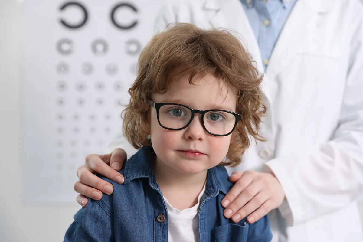 Miopia nei bambini, controllo della progressione miopica Ottica Contin Dolo: bambino con gli occhiali davanti alla tavola ottotipica